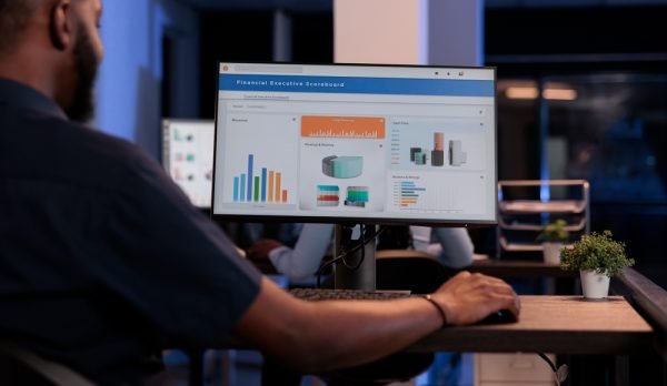 Executive,Manager,Looking,At,Computer,Monitor,With,Charts,,Analyzing,Statistics
